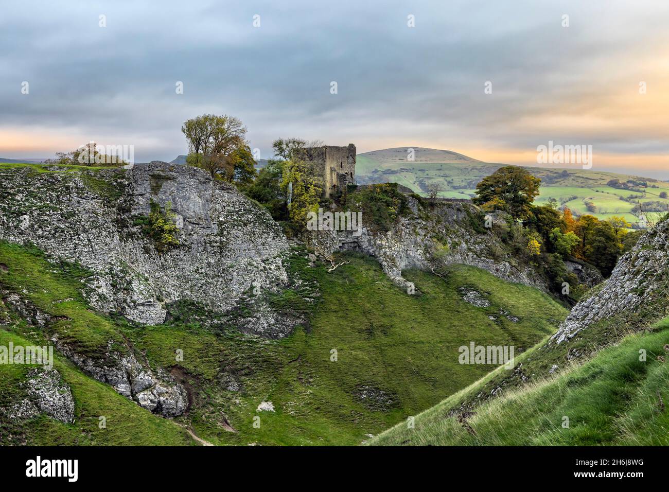 The ruins of Peveril Castle above Cave Dale near Castleton in the Peak District National Park, Derbyshire. Taken just after sunrise. Stock Photo