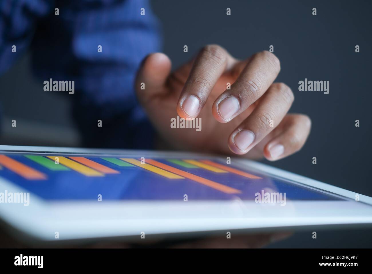 man's hand working on digital tablet at office desk, using self created ...