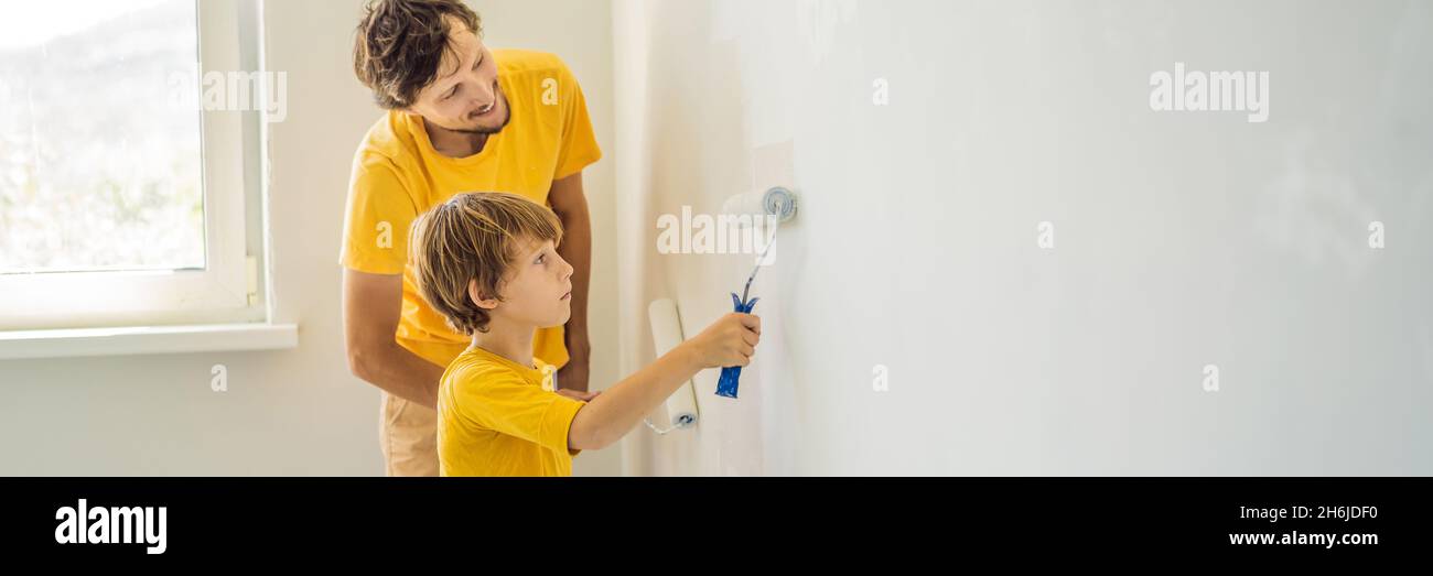 Father and son painting a wall in their home do it in the course of ...