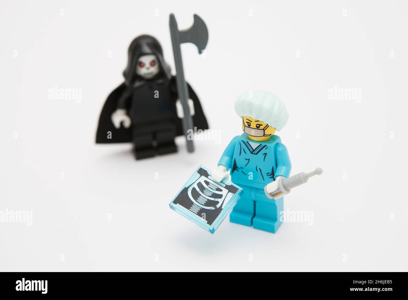 Doctor showing x-ray with grim reaper in background Stock Photo