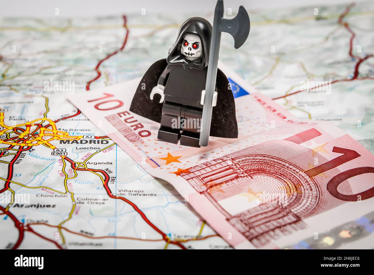 Death of the Euro - The grim reaper standing on a 10 Euro note on top of a map of Europe Stock Photo