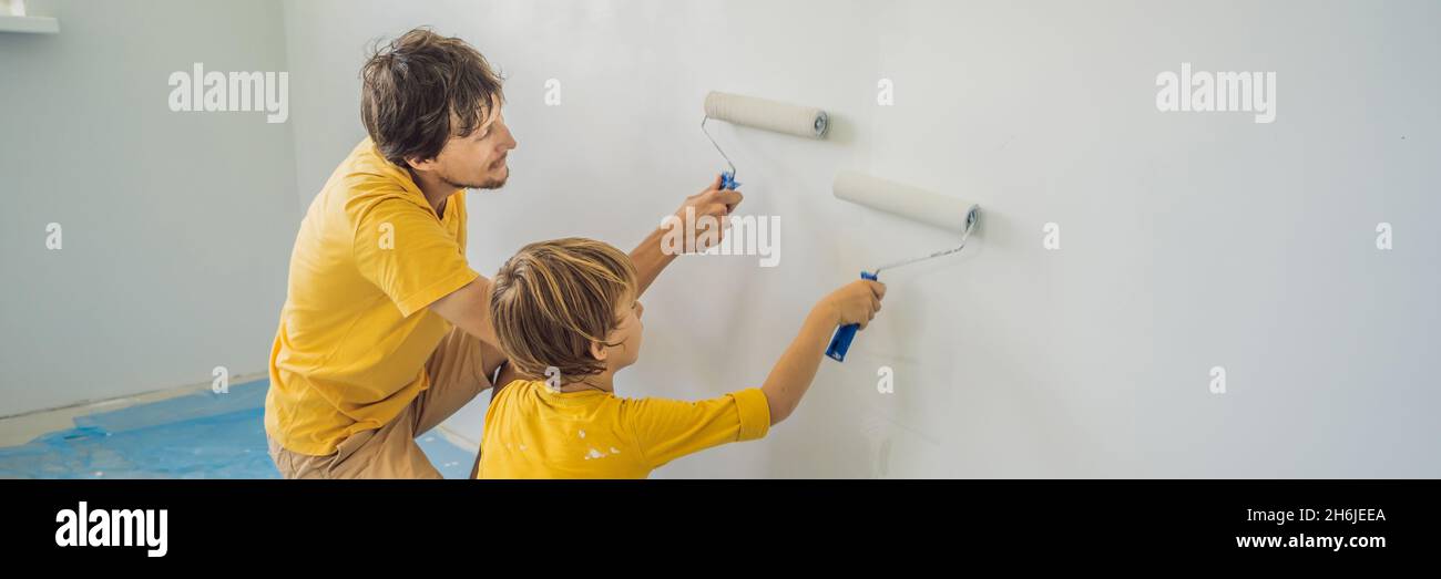 Father and son painting a wall in their home do it in the course of ...