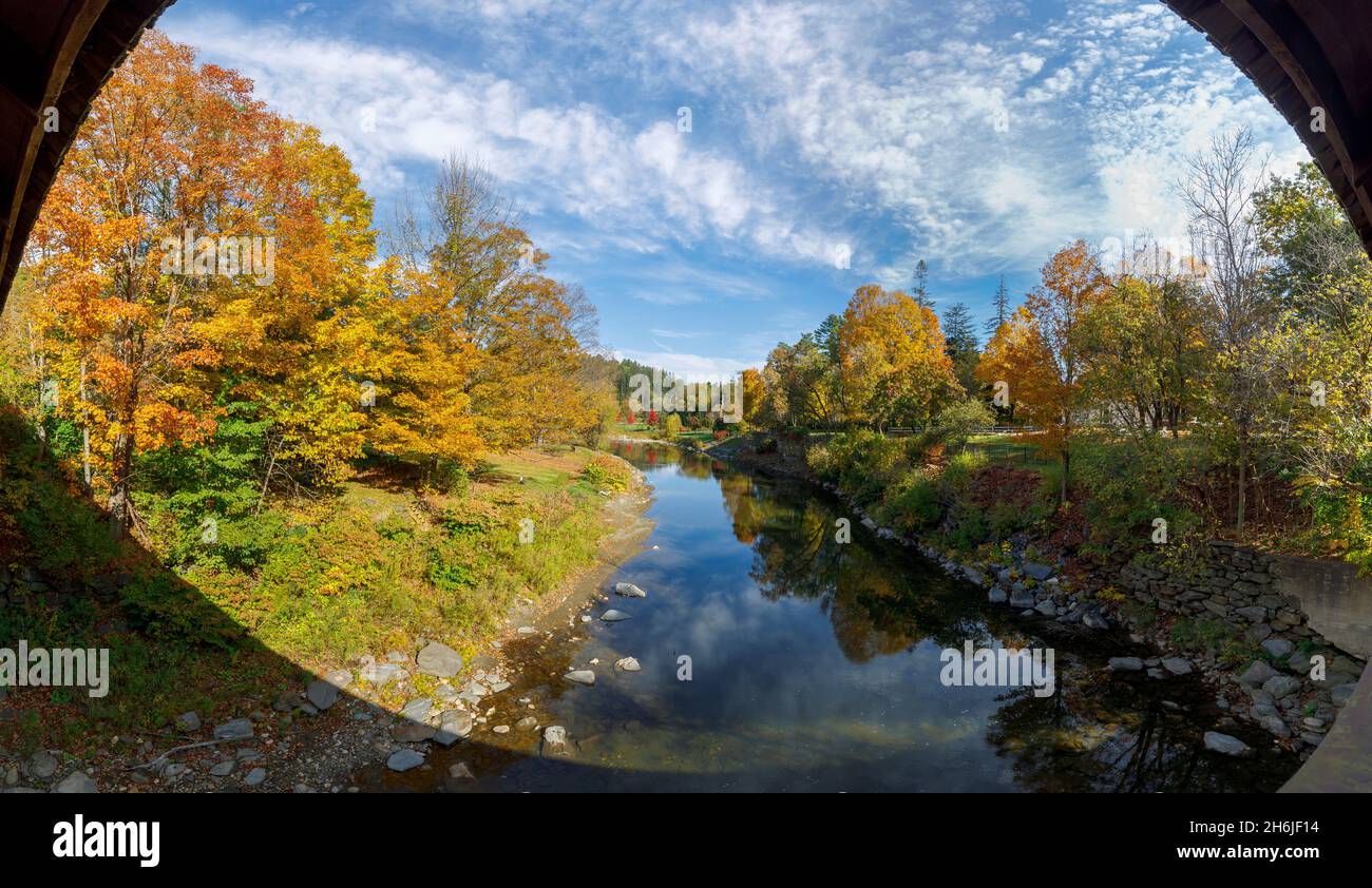 Panoramic view along the picturesque Ottauquelchee River from Middle Covered Bridge with vibrant fall colours, Woodstock, Vermont, New England, USA Stock Photo