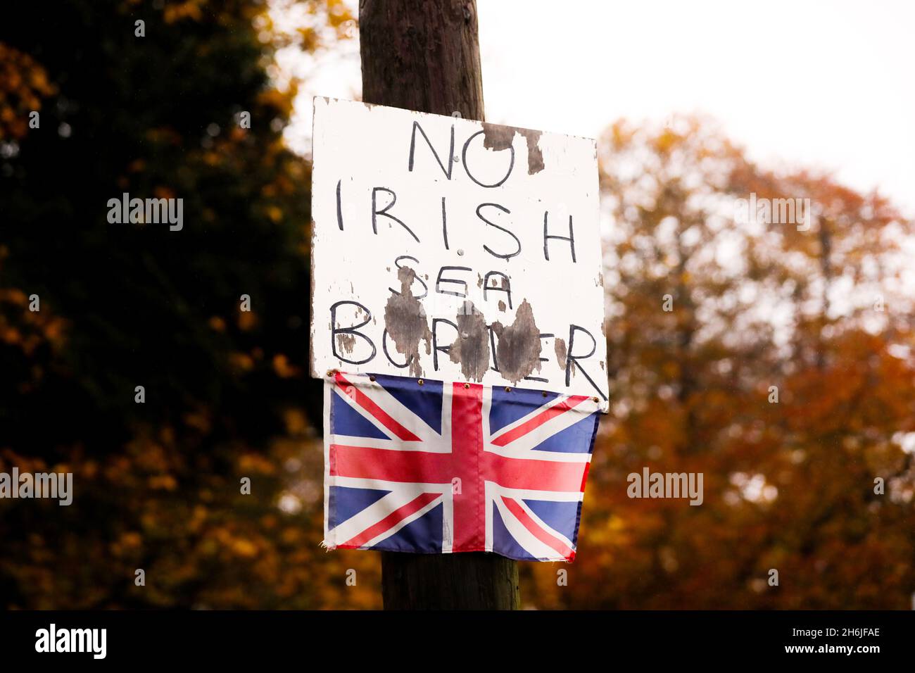 Anti Irish Sea Border placard and small Union Flag attached to a lamppost in Bangor, Northern Ireland, in opposition to the Northern Ireland Protocol. Stock Photo