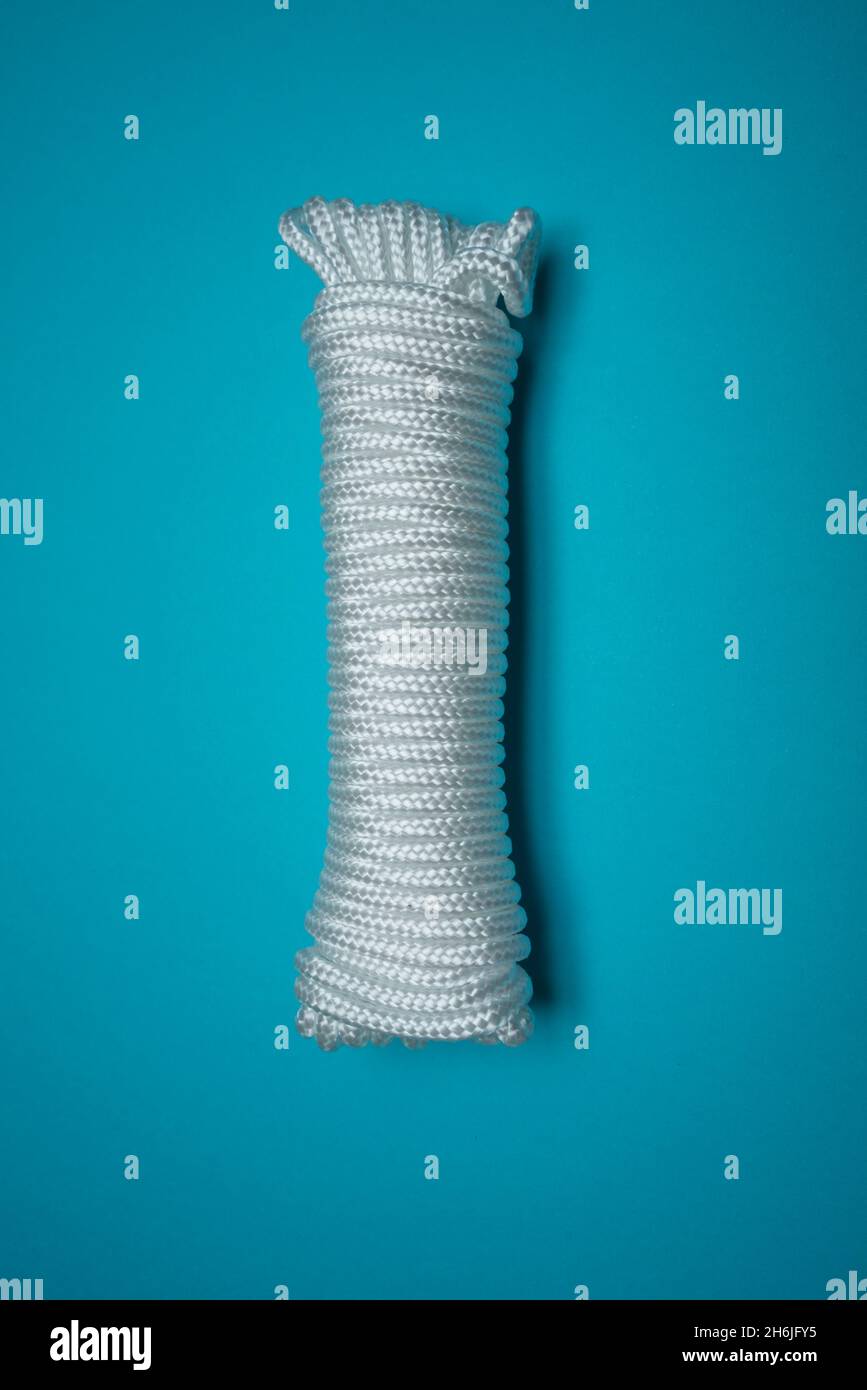 Coil of rope on blue background Stock Photo