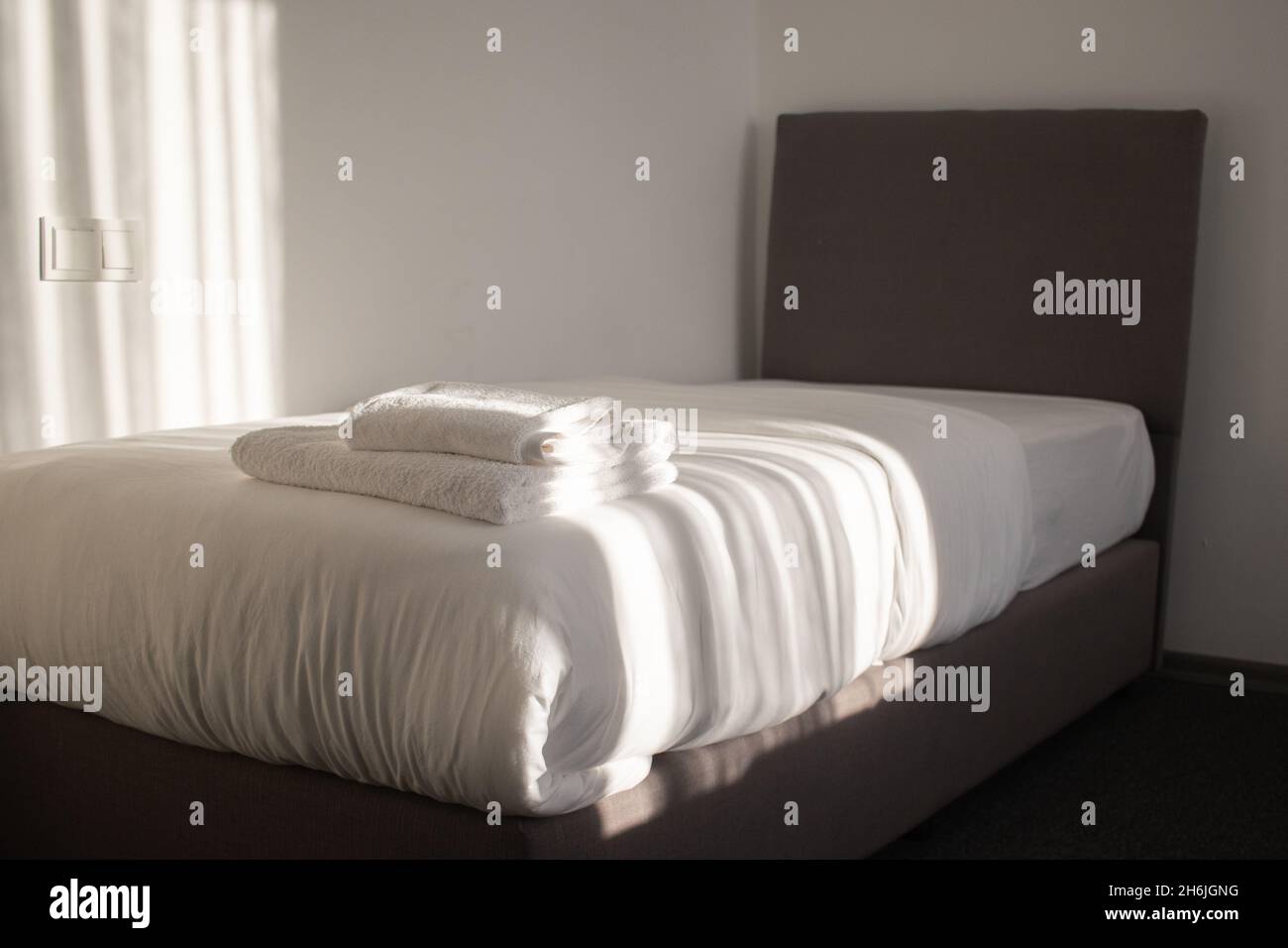 White clean towels stacked on the hotel bed Stock Photo Alamy