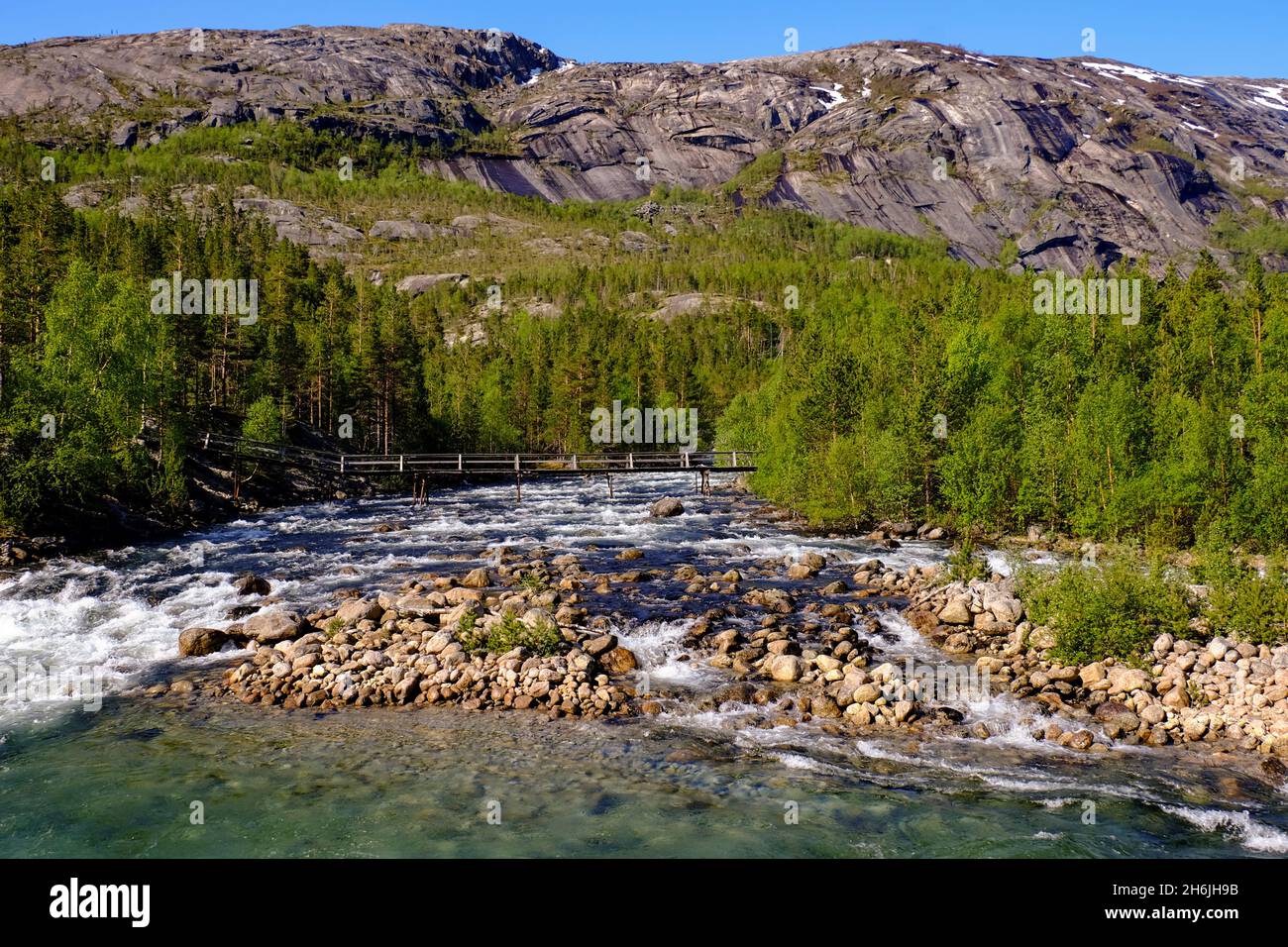 A pedestrian bridge extends over a glacial river, Tysfjord, Nordland, Norway, Scandinavia, Europe Stock Photo