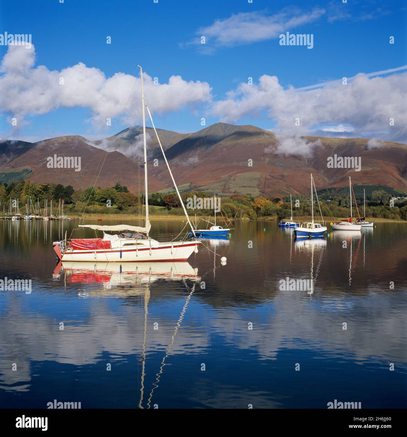 Yachts moored in Derwent Water in autumn morning sunlight, Keswick, Lake District, UNESCO World Heritage Site, Cumbria, England, United Kingdom Stock Photo
