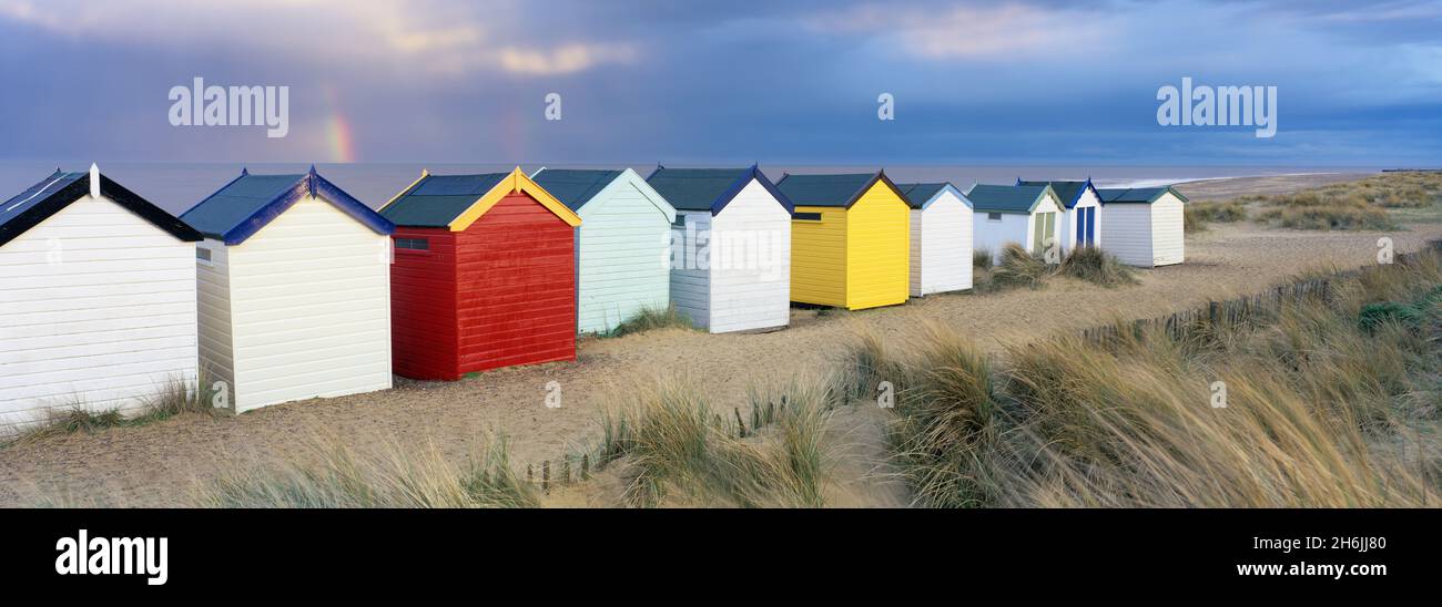 Beach huts and sand dunes with rainbow in evening light, Southwold, Suffolk, England, United Kingdom, Europe Stock Photo