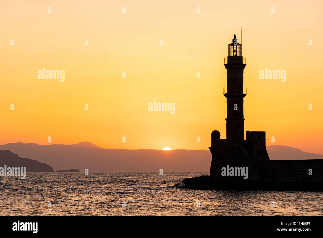 Silhouette of the old lighthouse at sunset, Chania, Crete, Greek Islands, Greece, Europe Stock Photo