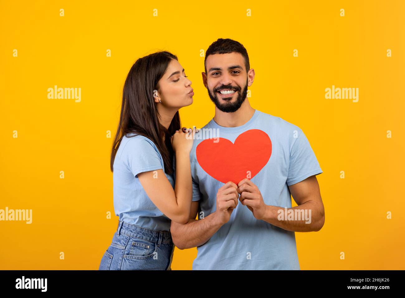 St. Valentines day concept. Portrait of loving arab couple holding red ...