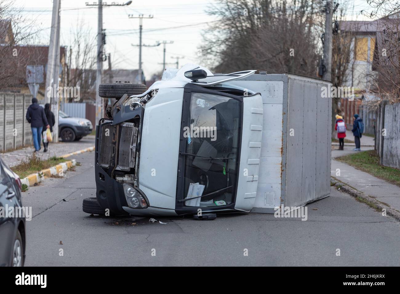 The truck is turned on its side and is lying on the street. Accident. Stock Photo