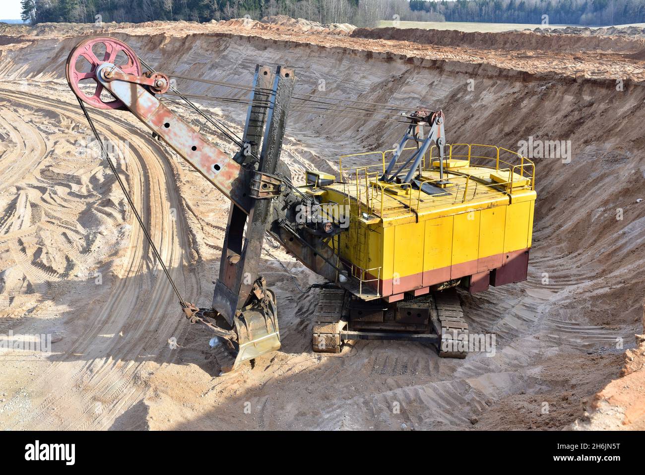 Huge mining excavator in the sand openpit. Biggest digger working in