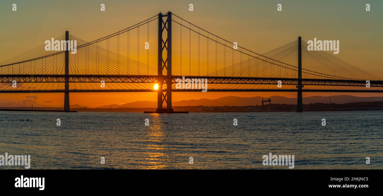 View of the Forth Road Bridge and Queensferry Crossing over the Firth of Forth at sunset, South Queensferry, Edinburgh, Lothian, Scotland Stock Photo