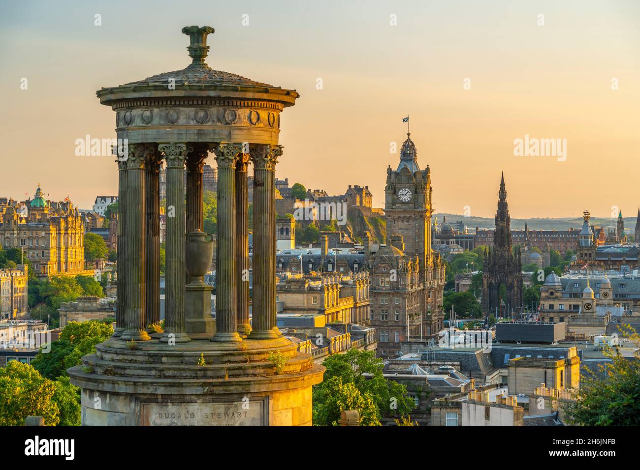 View of Edinburgh Castle, Balmoral Hotel and Dugald Stewart monument from Calton Hill at golden hour, USA, Edinburgh, Lothian, Scotland Stock Photo