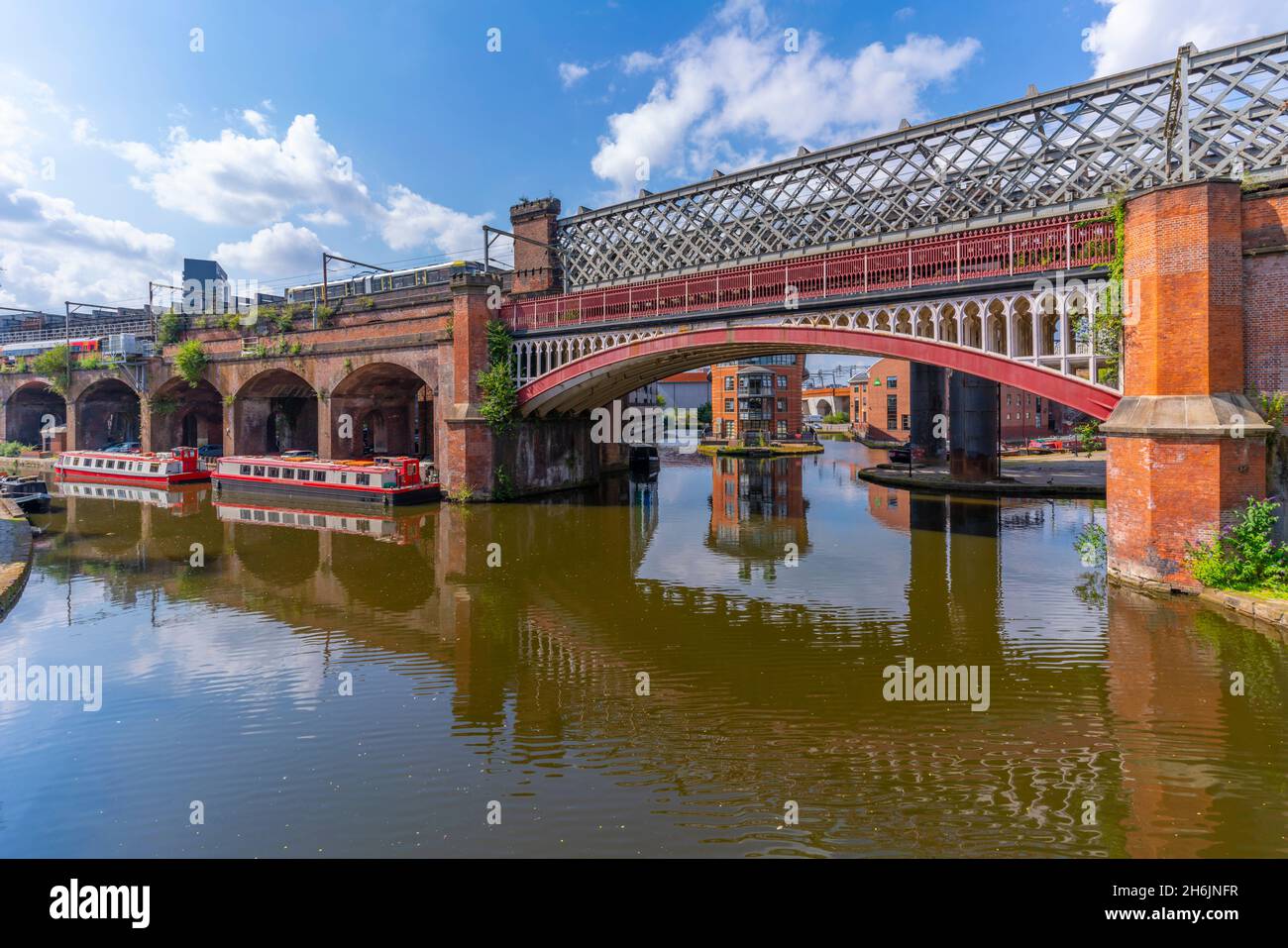 View of tram and train bridges reflecting in Castlefield Canal, Castlefield, Manchester, England, United Kingdom, Europe Stock Photo