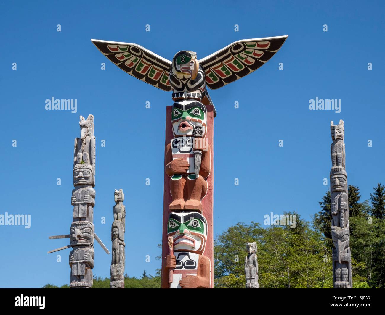 Kwakwaka'wakw totem poles in the cemetery in Alert Bay, Cormorant Island, British Columbia, Canada, North America Stock Photo