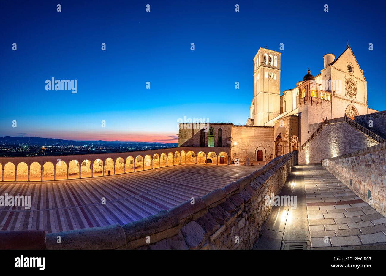 Panoramic of the illuminated arcade and Basilica di San Francesco during blue hour, USA, Assisi, Perugia province, Umbria, Italy Stock Photo