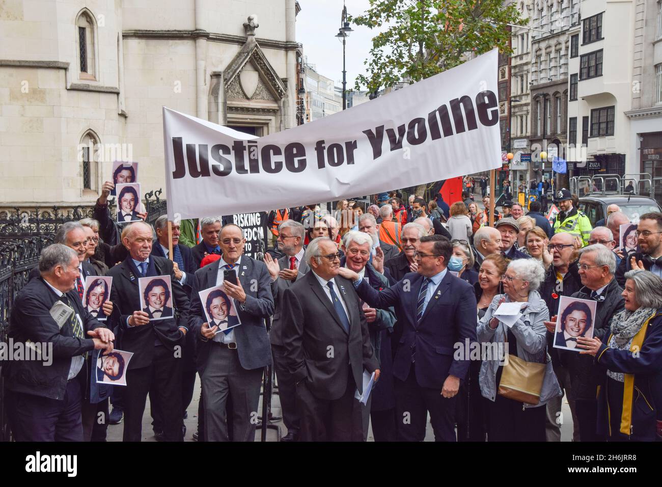 London, UK. 16th November 2021. Retired police officer John Murray with friends and supporters outside the Royal Courts of Justice. Saleh Ibrahim Mabrouk, a Libyan man close to Gaddafi, has been found jointly responsible for the fatal shooting of PC Yvonne Fletcher outside the Libyan Embassy in 1984, in a civil case brought by her former colleague and friend, John Murray. Credit: Vuk Valcic / Alamy Live News Stock Photo