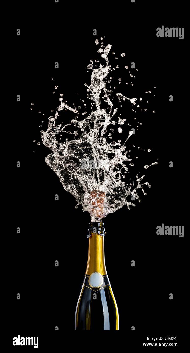 champagne bottle with cork flying with splashing liquid on black