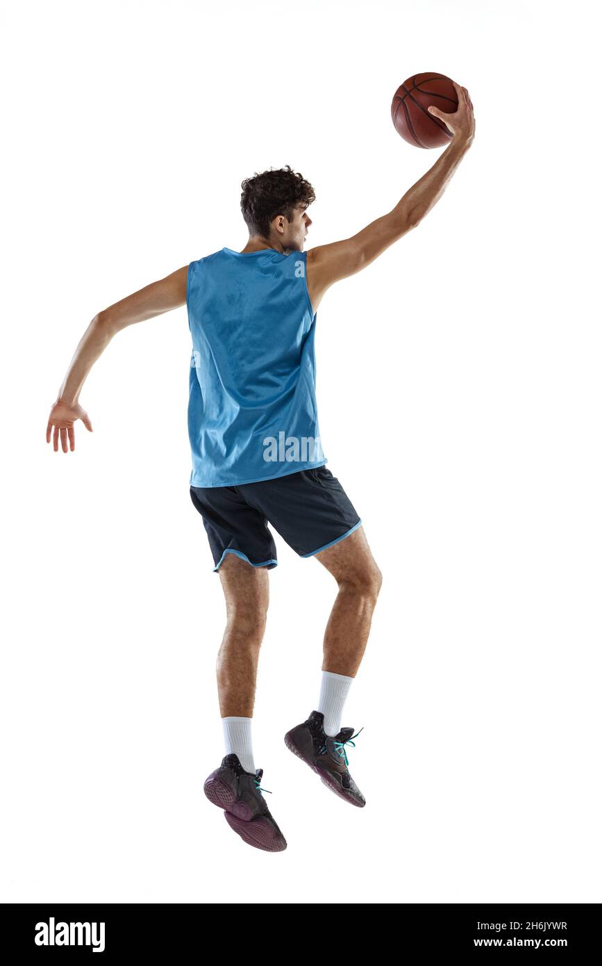 Back view. Portrait of basketball player training isolated on white studio  background. Tall muscular athlete jumping with ball Stock Photo - Alamy