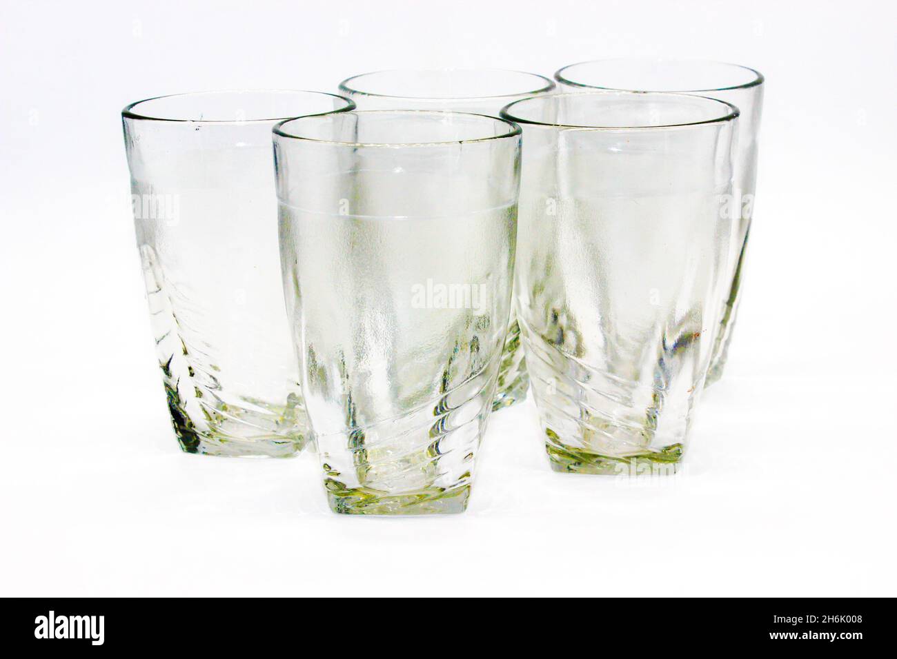 Glass tumblers on white background with selective focus Stock Photo