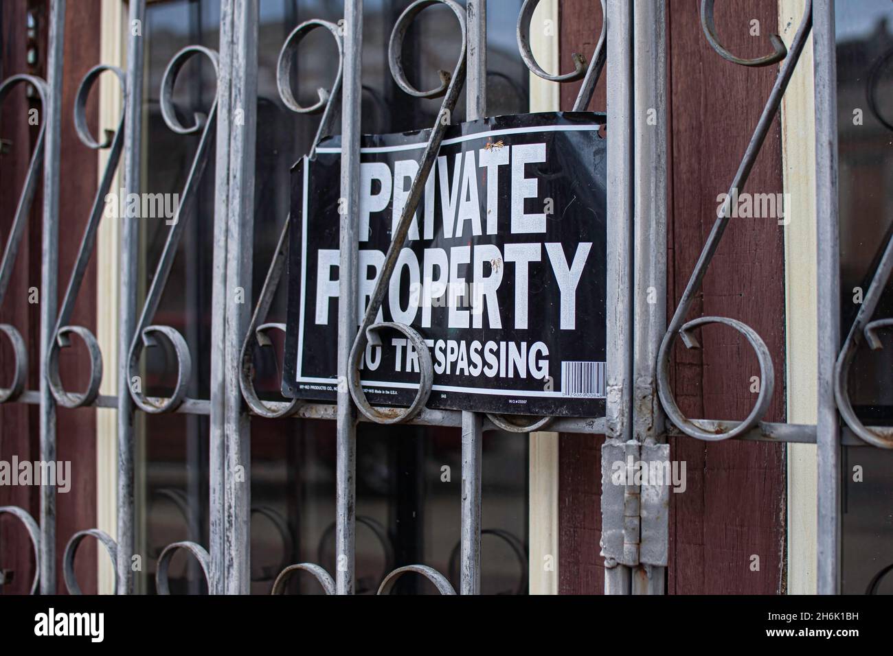 Private property sign on a door with bars Stock Photo Alamy