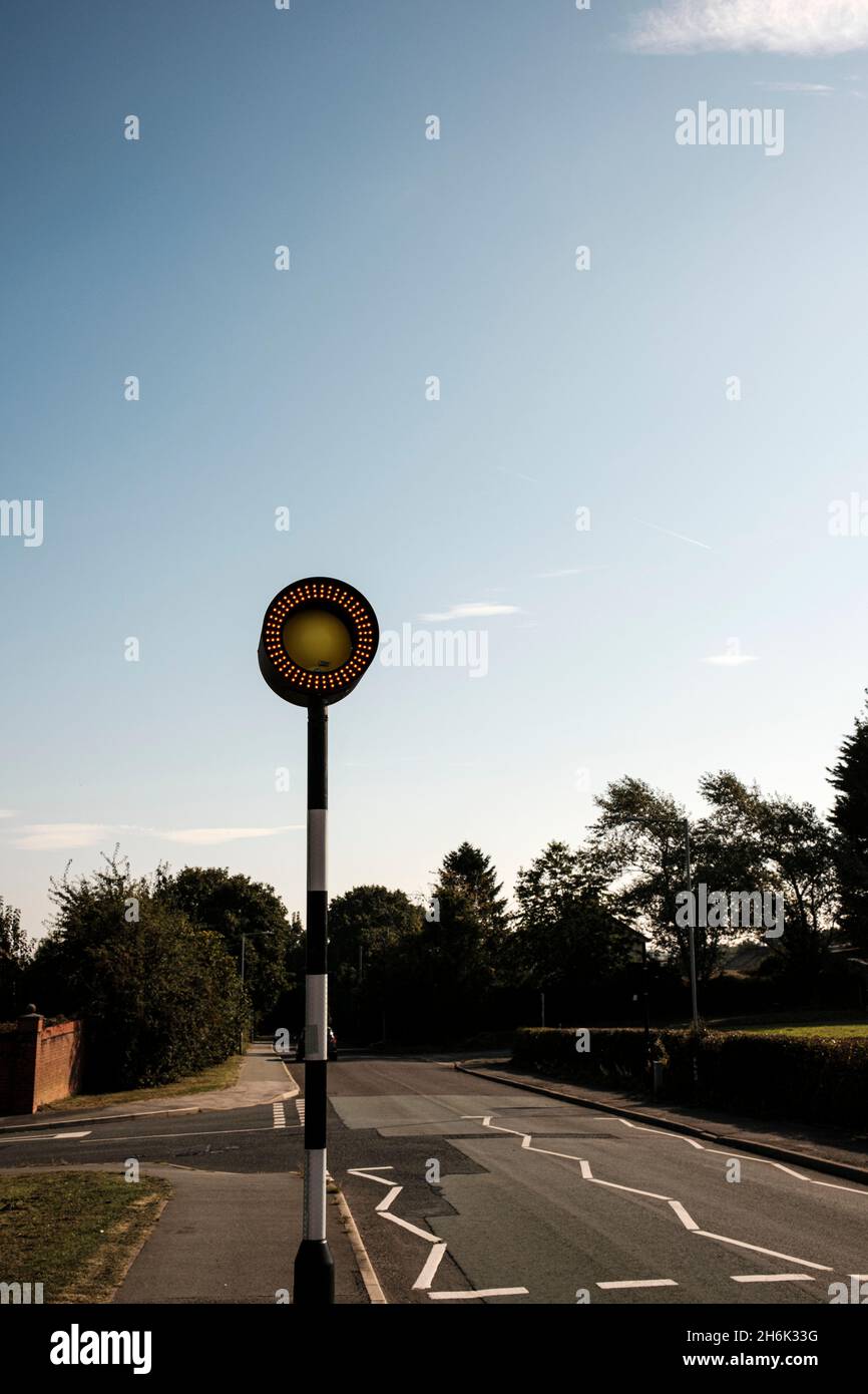 Belisha beacon with circular row of LED lights at a zebra crossing in Buckley, Wales, UK, Stock Photo