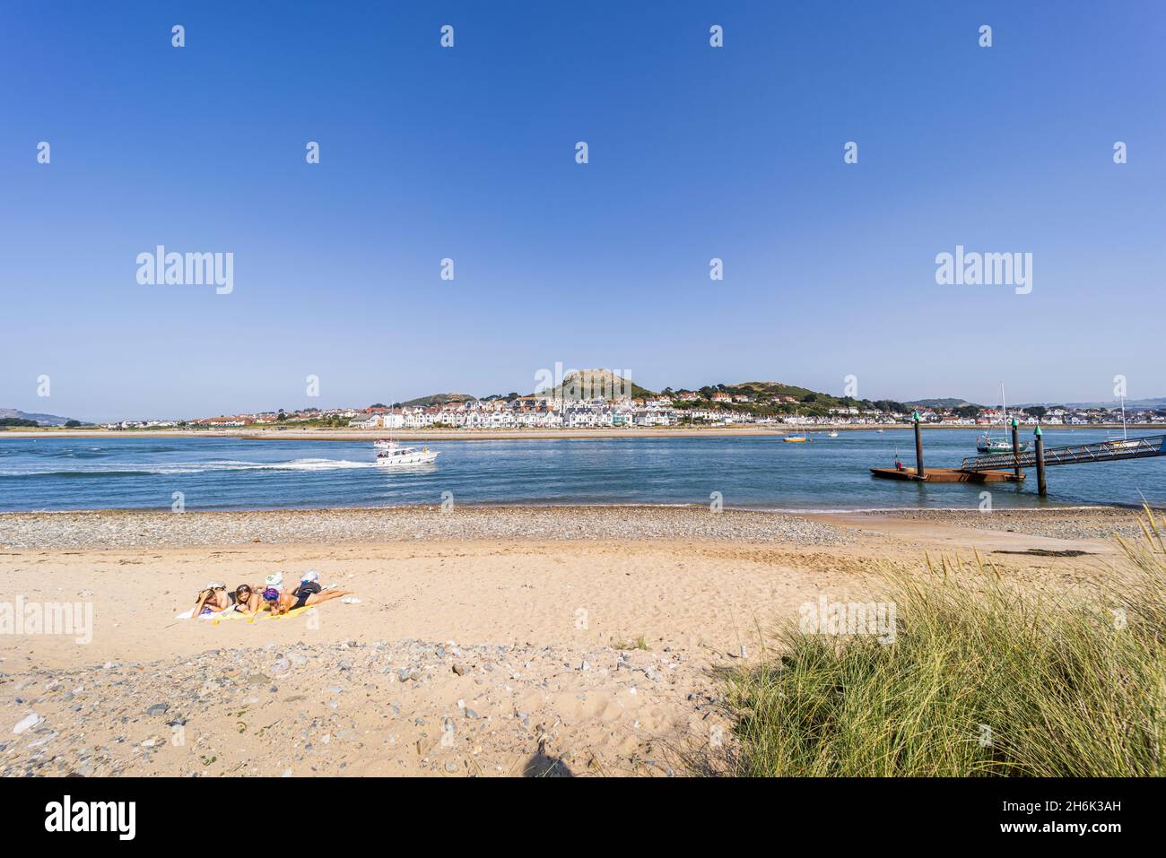 On the beach looking over the river Conwy estuary towards Deganwy on a sunny day, Conwy, Wales, UK, Stock Photo