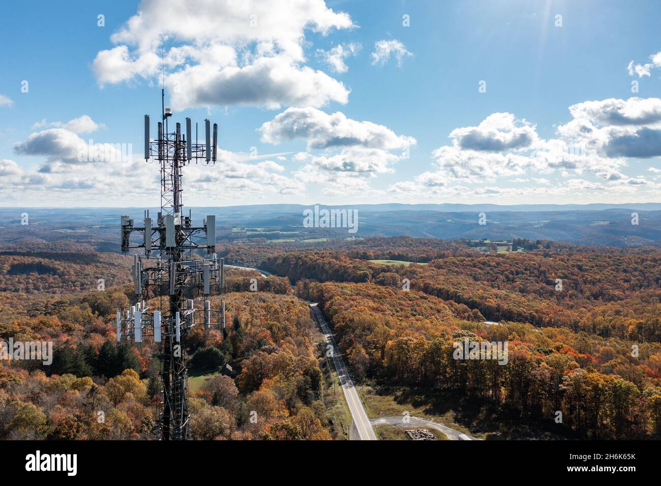 Aerial view of mobile phone cell tower over forested rural area of West Virginia to illustrate lack of broadband internet service Stock Photo