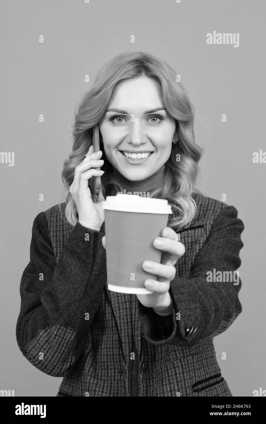 Good morning. Happy woman give cup talking on phone. Enjoying her morning coffee Stock Photo
