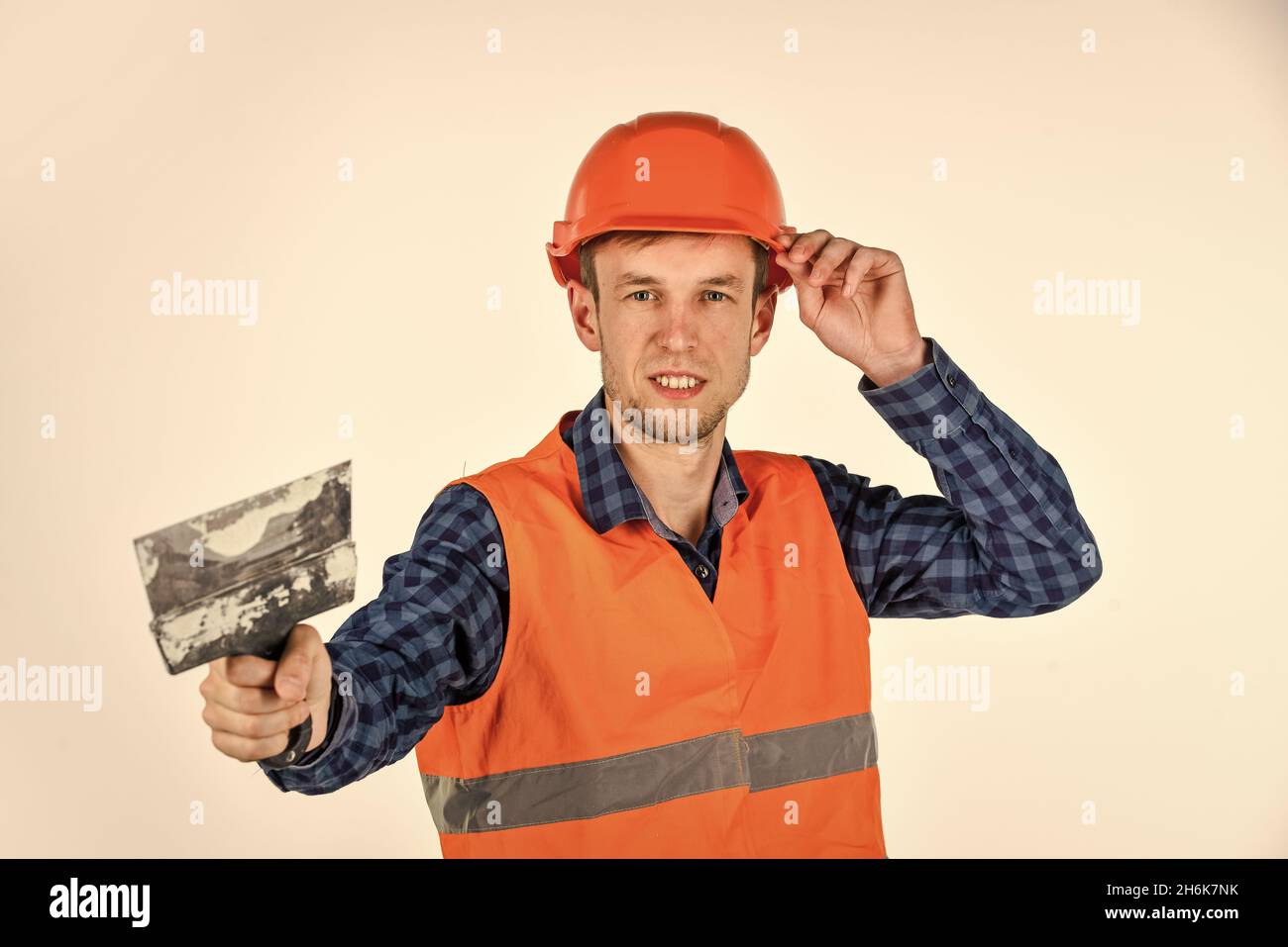 Plasterer in working uniform plastering tool putty knife, new home concept Stock Photo