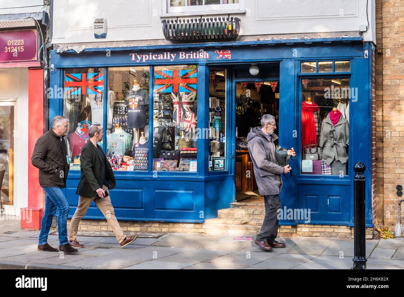 People look at souvenirs for sale in 'Typically British' souvenir shop, Cambridge, UK. Stock Photo