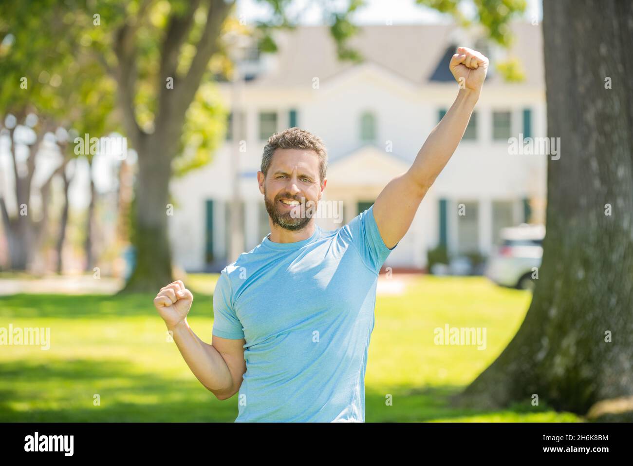 success concept. real estate agent at house for sale. realtor welcoming visitors. Stock Photo