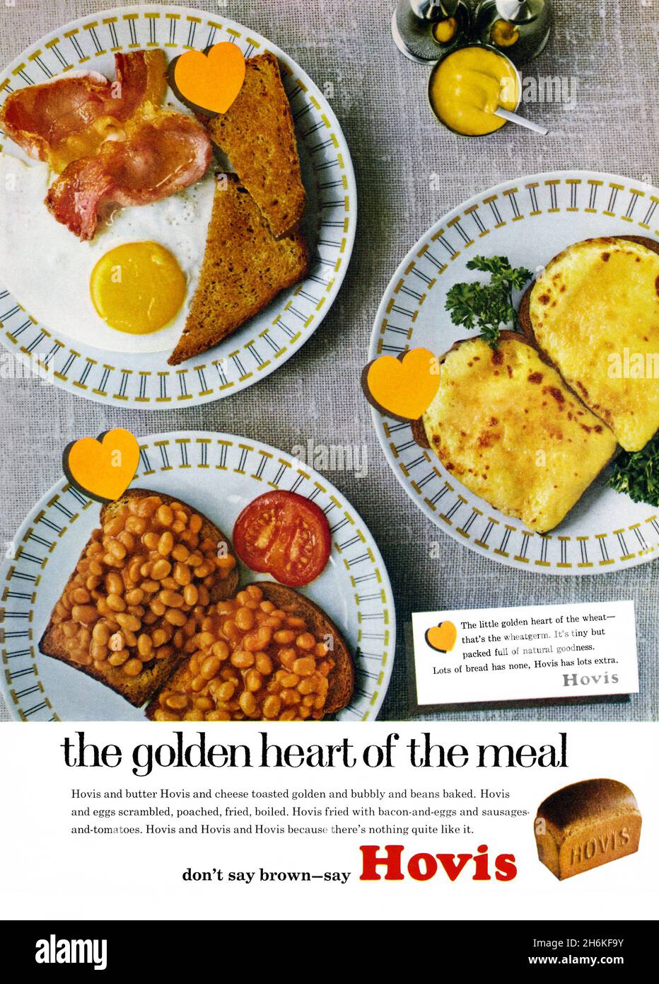 A 1960s advert for Hovis bread. The advert appeared in a magazine published in the UK in March 1965. The photograph shows some plates of breakfast dishes – beans on toast, a fry-up and melted cheese on toast. Graphic gold ‘hearts’ indicate that Hovis is ‘the golden heart of the meal’. At the base is the popular slogan ‘Don’t say brown – say Hovis’. Hovis Ltd is a British company that produces flour and bread. The brand originated in Stoke-on-Trent and was first mass-produced in Macclesfield, Cheshire, in 1886 – vintage 1960s graphics for editorial use. Stock Photo