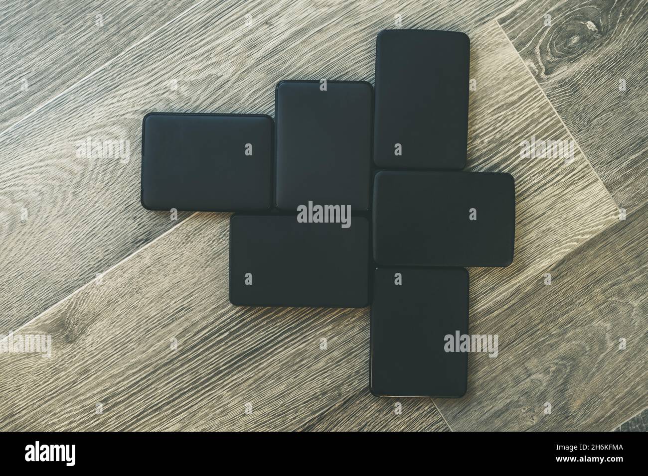 Many portable hard drives on the wooden floor. Mosaic of usb storage ...