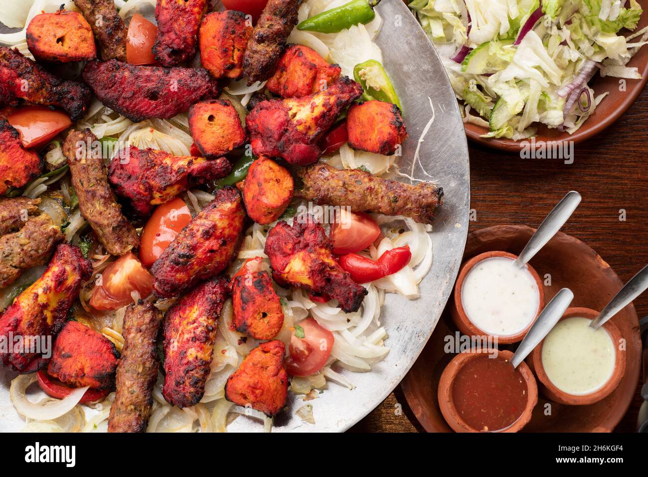 Sheffield UK – 11 May 2018: Afghan shared platter meal for four with spicy grilled vegetables, sheesh kebab and tikka chicken wings Stock Photo