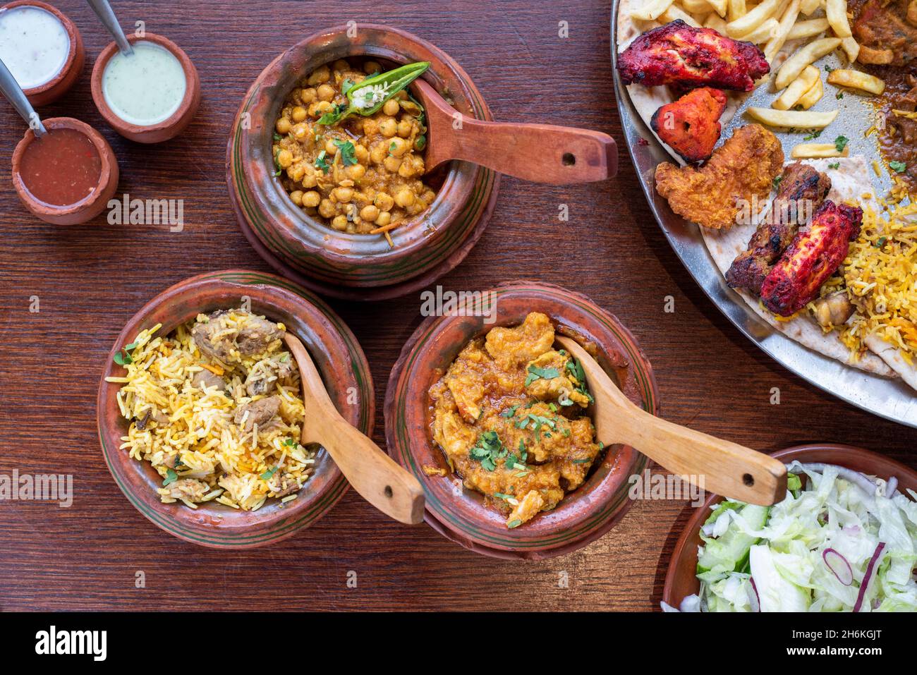 Sheffield UK – 11 May 2018: Afghan style chicken and chickpea curry, pilau rice and a mutton curry and tikka chicken sharing platter Stock Photo