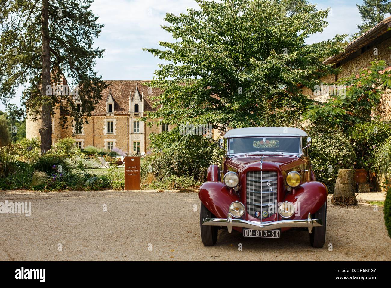 Bordeaux, France - 2019: Retro car Auburn 654 standing on beautiful background of old chateau. Luxury, expensive red automobile. Rare american car bra Stock Photo