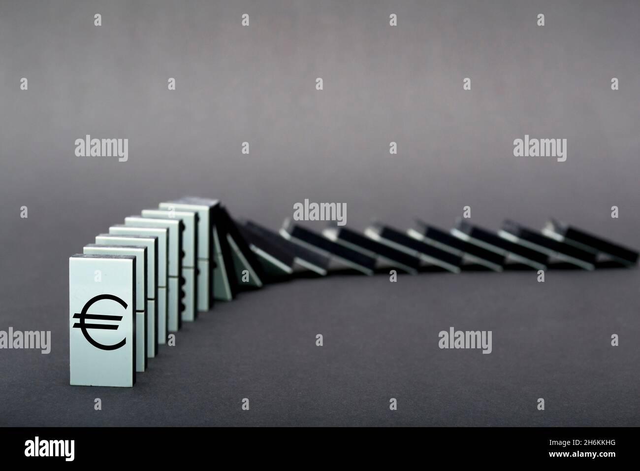 Dominoes falling in a row , gray background Stock Photo - Alamy