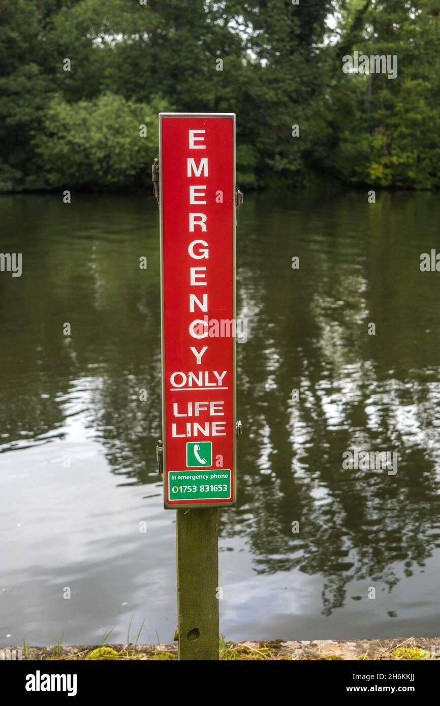 Emergency lifeline water safety equipment and sign on the River Thames at Windsor Berkshire England Stock Photo