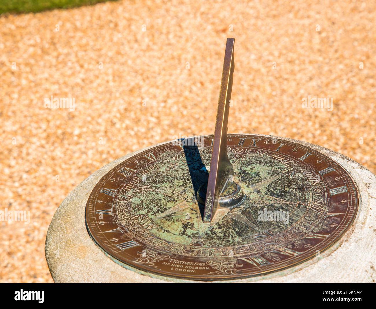Old Watson and sons engraved brass sundial with compass showing time and direction with the suns shadow Stock Photo