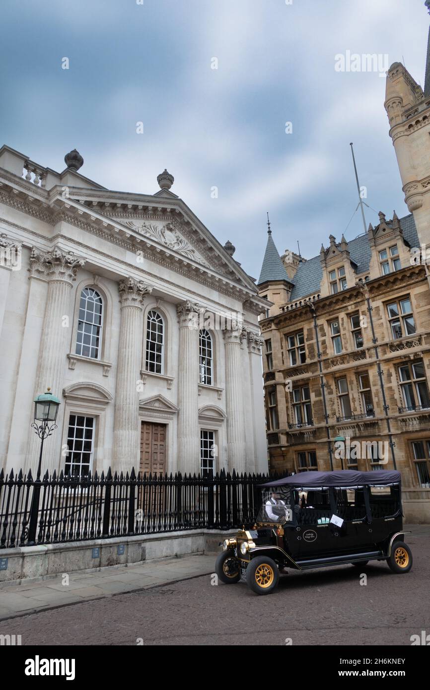 An electric Model Ts car parked outside the Senate House and Gonville and Caius college. Being used for green tours around Cambridge England Stock Photo