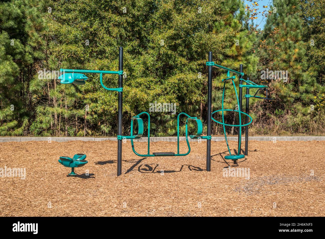 Unique playground equipment that does many different things swings twirls spin at a park outdoors on a sunny day Stock Photo