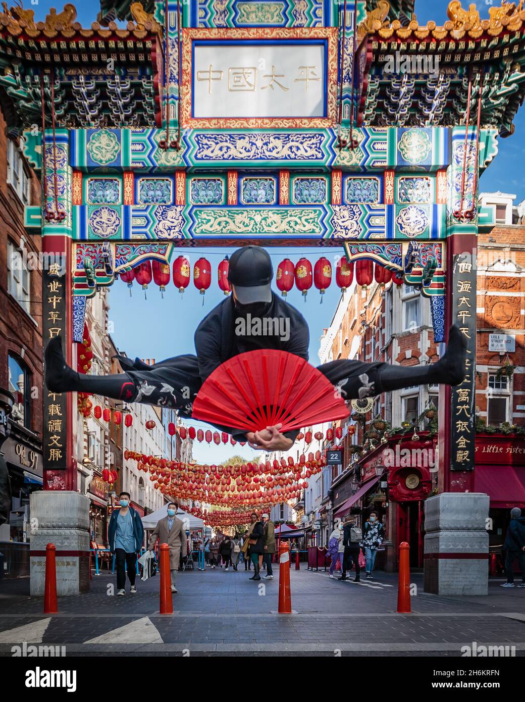 An impressive split leap by Chinatown in London. Stock Photo