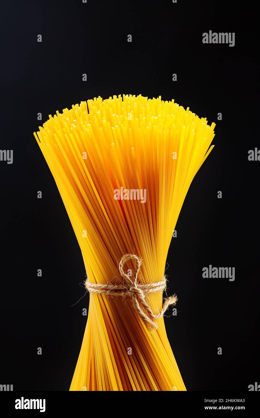 macaroni unprepared raw rope tied spaghetti from durum wheat handmade Stock Photo