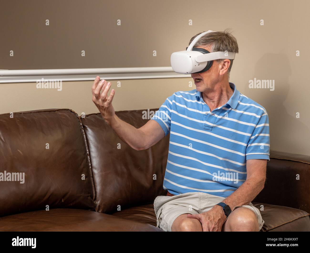 Senior man reaching for object on a modern virtual reality VR headset