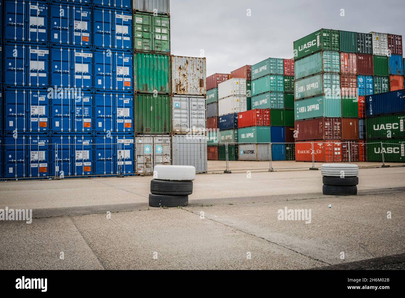 Shipping containers stacked in a holding zone Stock Photo