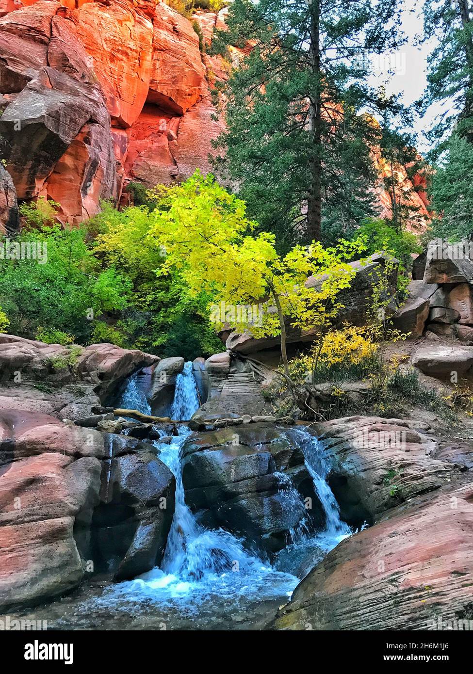 Beautiful view of the streaming rocky waterfall in the park Stock Photo ...