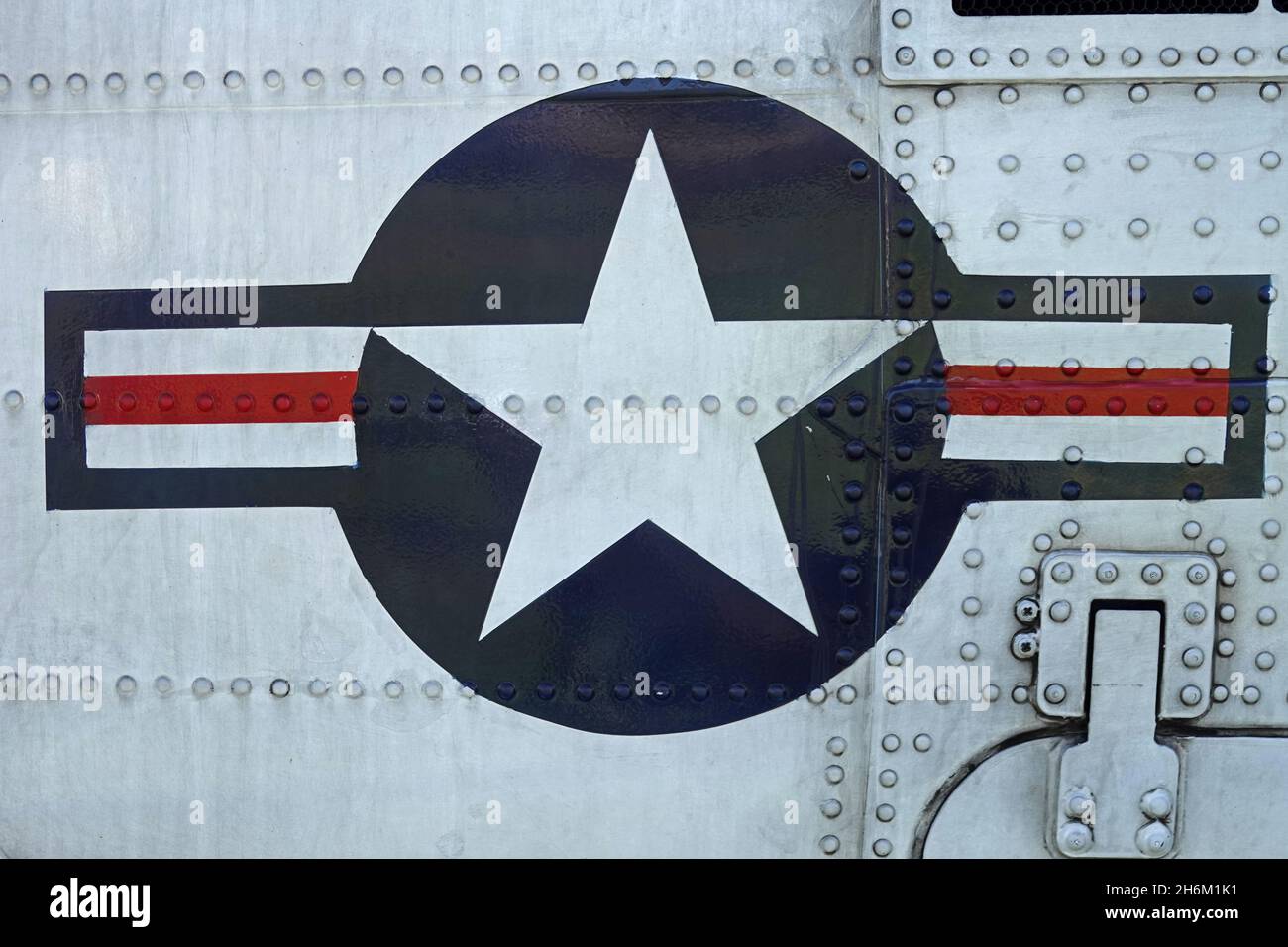 A red, white, and blue roundel logo signifying United States of America military aircraft is shown painted on a helicopter up close. This insignia ver Stock Photo
